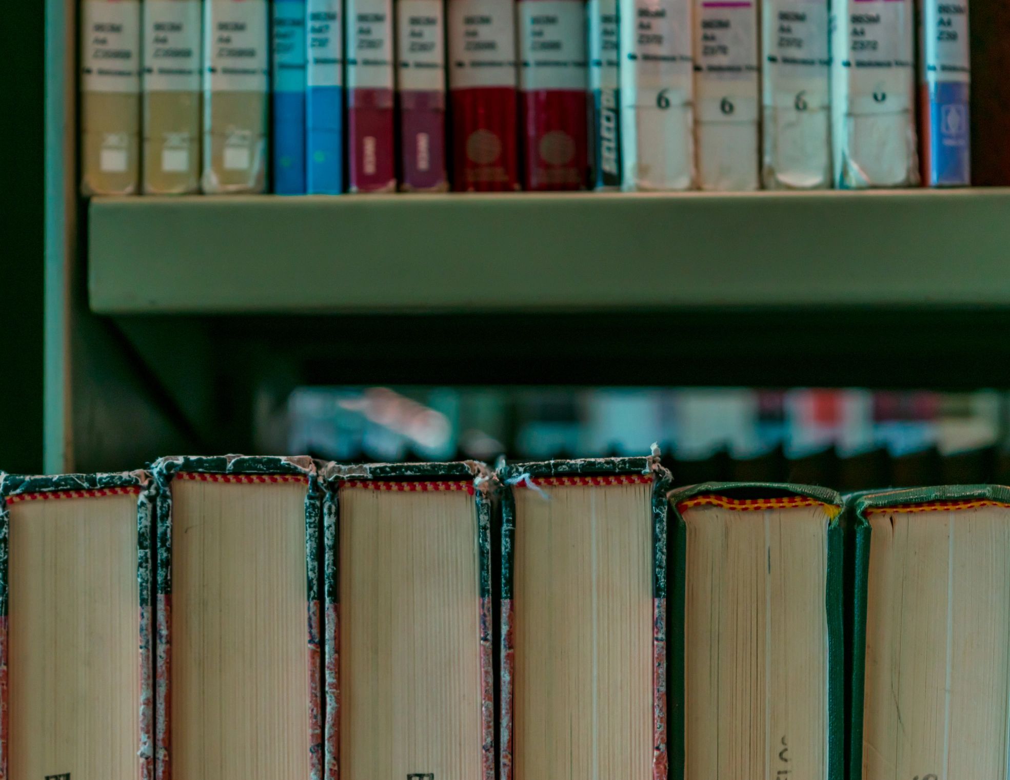 Books on a library shelf representing publications and learning
