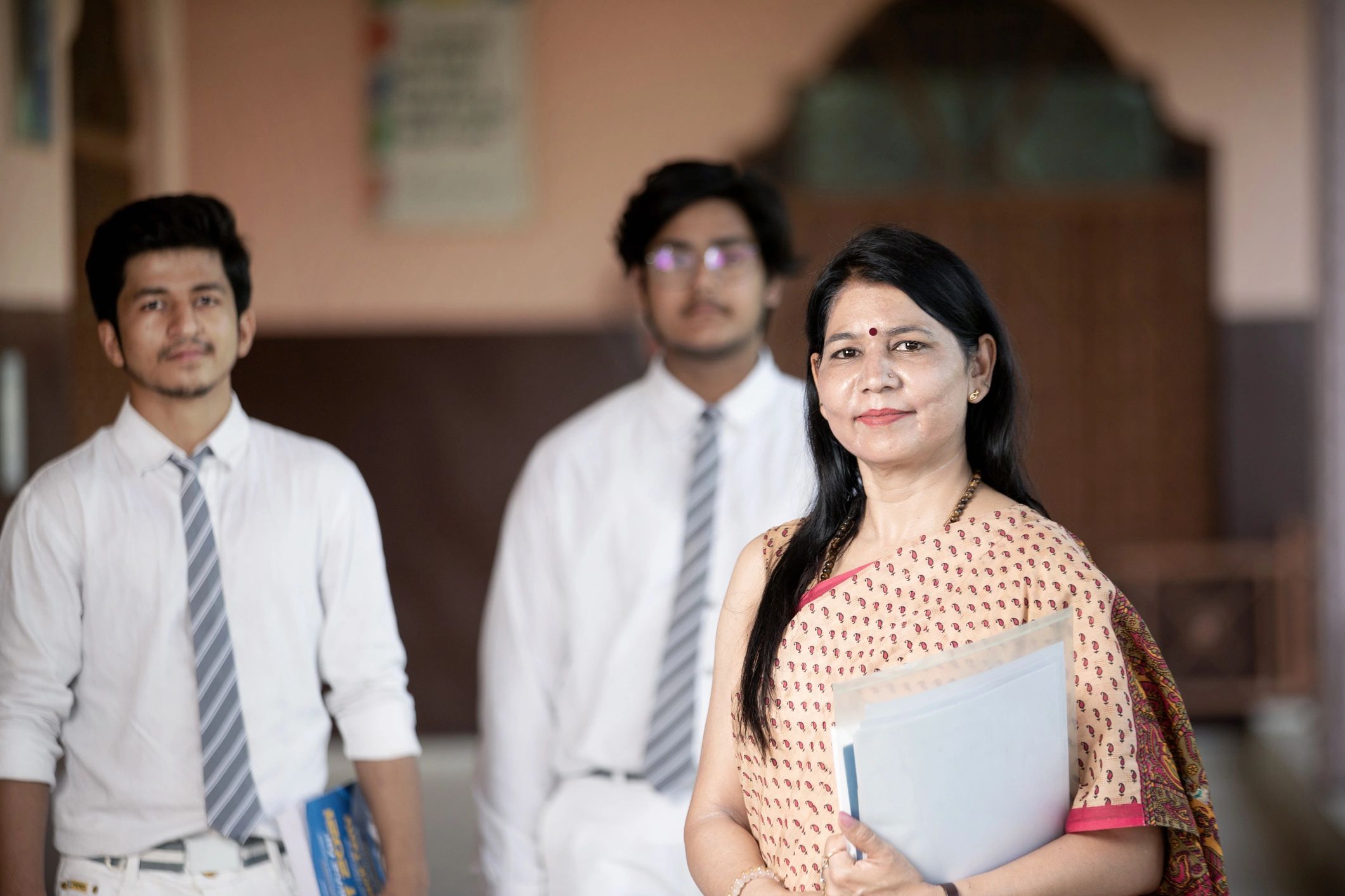 Indian teacher with students in classroom