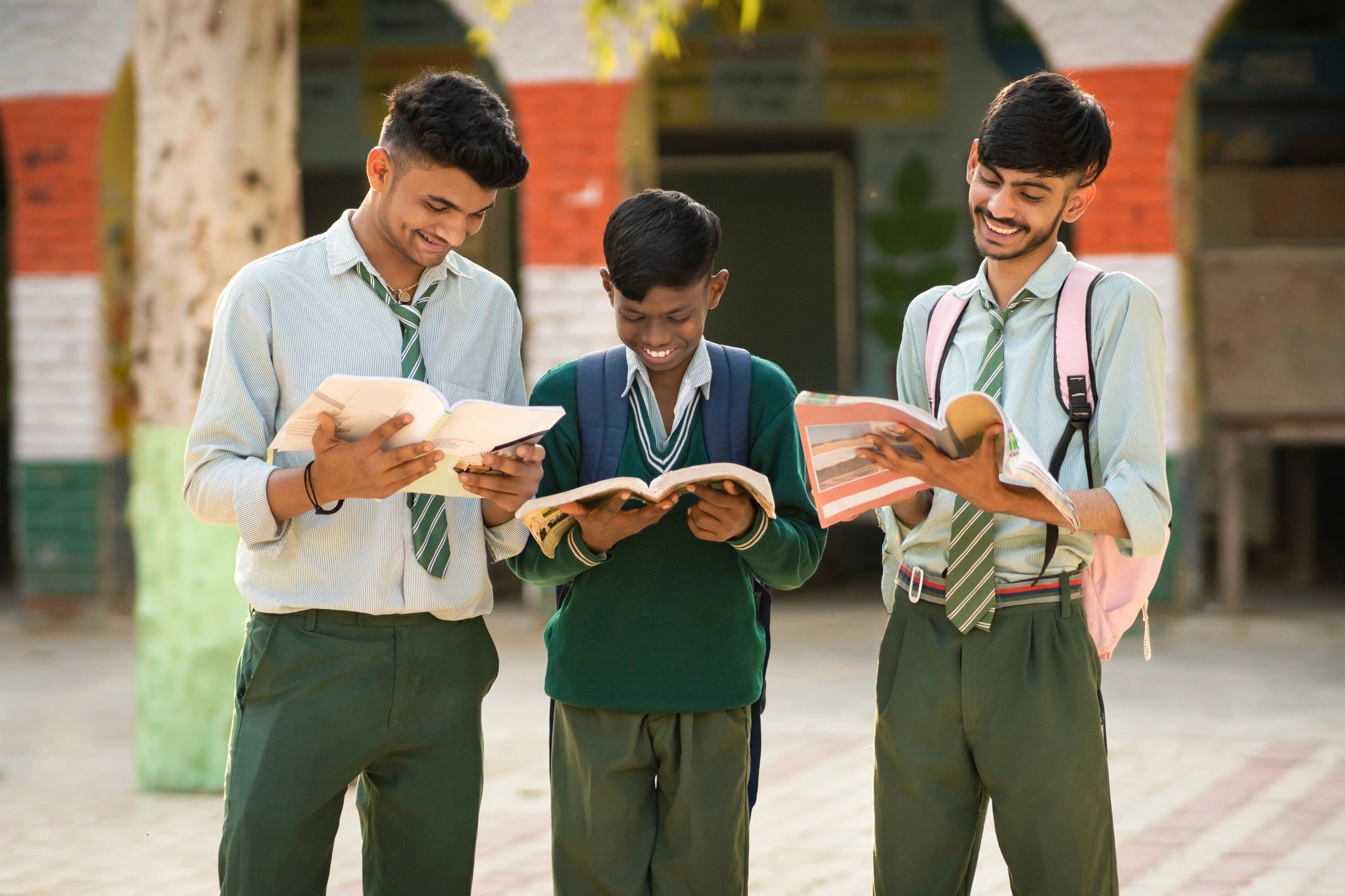 Students reading together and using reference materials